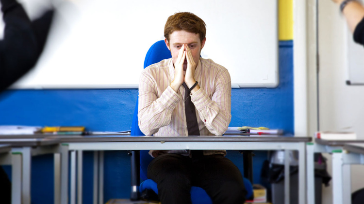 Stressed teacher at desk