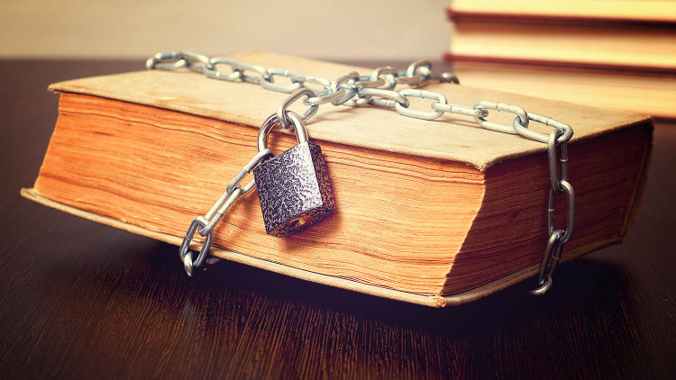 Old book bound by lock and chain