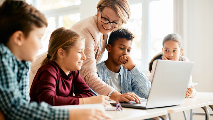 Stock image of teacher with group of young teen students