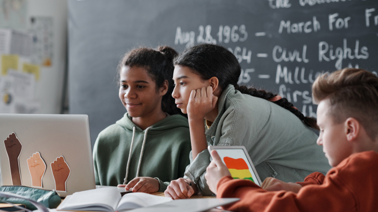 Photograph of three students working together 