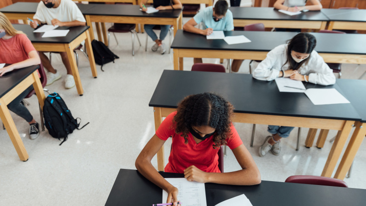 High school class taking test in masks