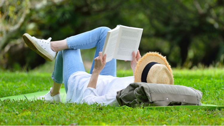 Woman reading on grass